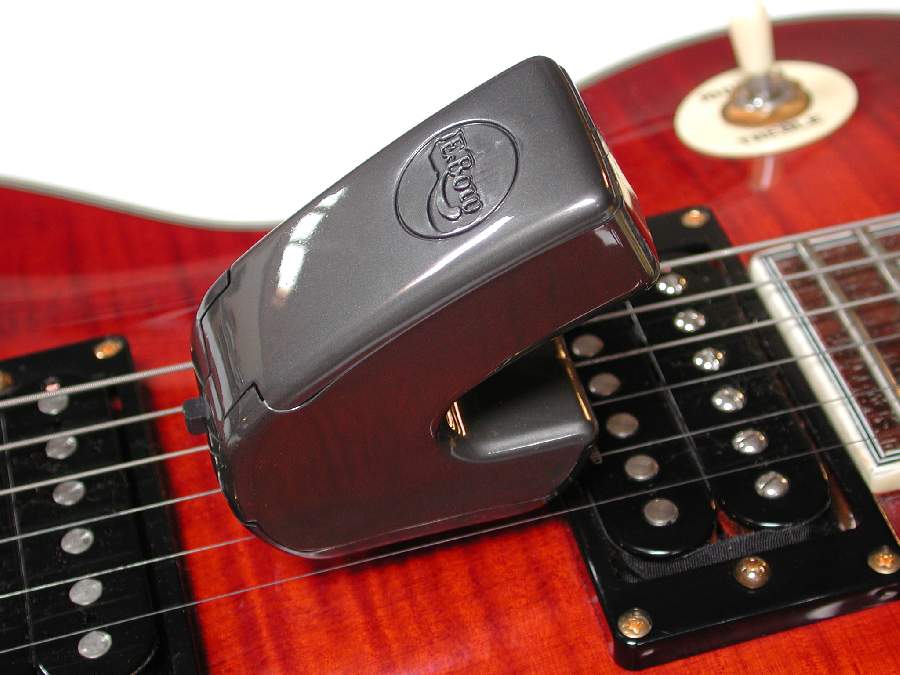 EBow on guitar strings near the pickup