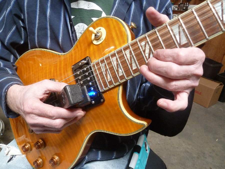 Playing EBow on an electric guitar — official manufacturer photograph